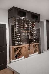 Wine cellar in dining room made with custom glass