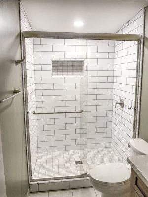 framed shower door in stainless