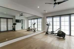 Workout gym with a elliptical and a large gym wall mirror