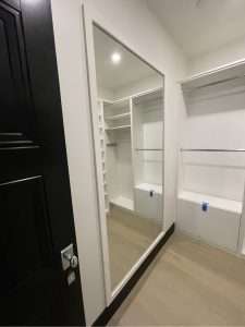 Inset wall mirror in a walk in wardrobe closet